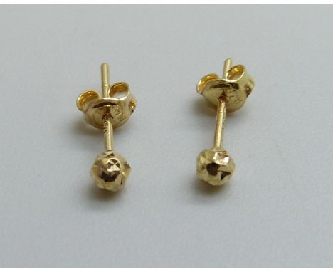 A pair of 9ct gold diamond cut stud earrings, 0.3g