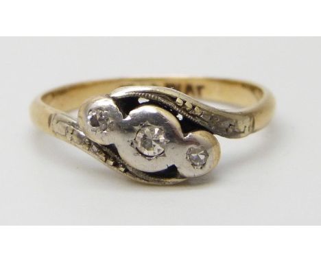 An 18ct gold and platinum set three stone diamond ring, 2.3g, L/M