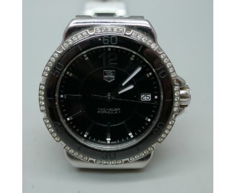 A Tag Heuer Formula 1 lady's diamond set wristwatch with stainless steel bracelet, bracelet fastener a/f, 37mm including crow
