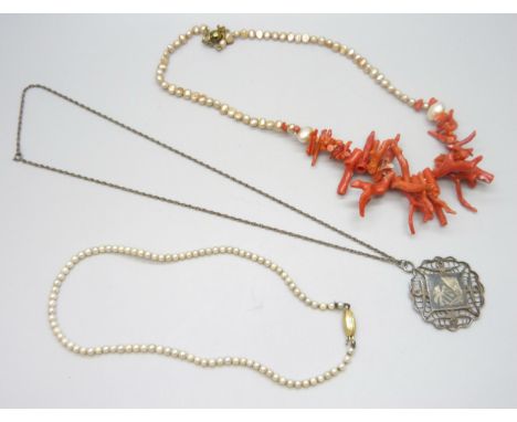 A coral necklace, a pearl necklace with an 18ct gold fastener, and a white metal filigree necklace with niello detail
