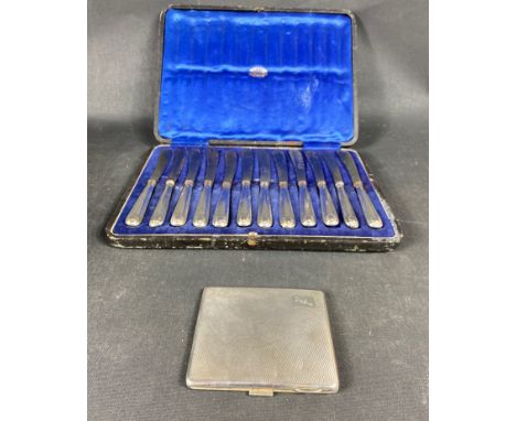 A set of twelve silver handled butter knives in fitted Edinburgh retailers case.  Some handles detached and with wear.  Gross