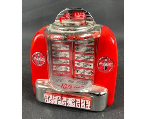 A working model COCA COLA JUKE BOX from 1996 (JB 15715), plays a selection of vintage Coke advertising jingles on insertion o