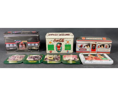 Four COCA-COLA tins to include a reproduction 1953 tin with 2 unopened packs of Christmas playing cards,  a ROADSIDE DINER fi