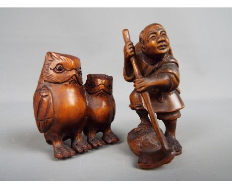 Two carved wood netsuke, the first depicting two owls, the other depicting a rice farmer, bothe signed.