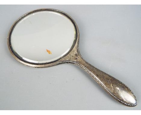 A George V silver hallmarked dressing table hand mirror, Chester assay 1923, makers mark for J &amp; R Griffin.