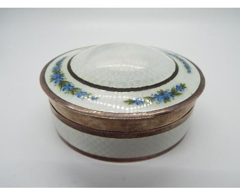 A George V silver and enamel dressing table trinket box, the light blue guilloche enamel with hand painted floral decoration 