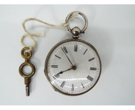A lady’s silver cased pocket watch, case having engraved floral decoration, white enamel dial with Roman numerals, matched bl