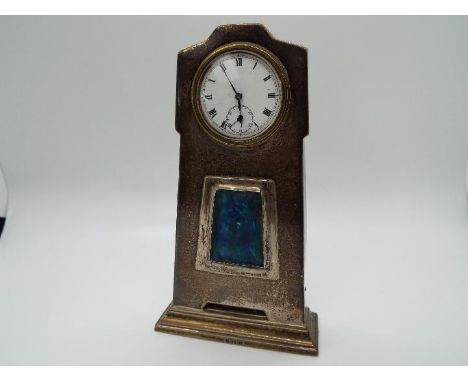 A small silver cased Art Nouveau style desk clock or watch, the case of silver laid on a wooden carcass and having Birmingham