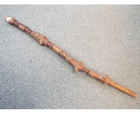 A Rastafarian carved stick, approximately 114 cm.