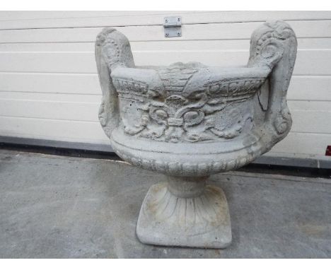 Garden Stoneware - A large reconstituted stone two handled decorative urn planter in two pieces