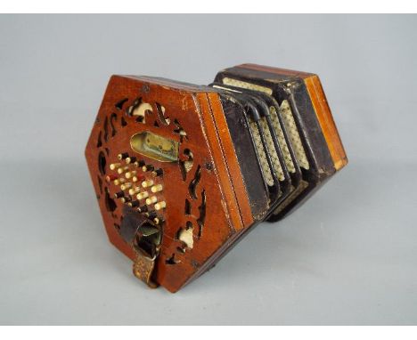 A Lachenal &amp; Co 48 button concertina with hexagonal fretworked ends, serial number slightly indistinct but appears to be 