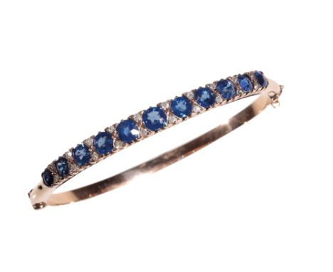 A SAPPHIRE AND DIAMOND BANGLE the eleven graduated&nbsp; cushion-cut sapphires interspersed with round-cut diamonds, half set