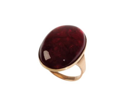 A RED AMBER DRESS RING, the oval-cut amber approx 18mm x 27mm collet-set on an unmarked yellow metal shank, ring size N