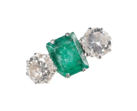 AN EMERALD AND DIAMOND THREE STONE RING the trap-cut emerald approx 1.25ct, flanked either side with a brilliant-cut diamond 