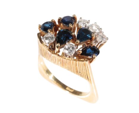 A MODERNIST SAPPHIRE AND DIAMOND CLUSTER RING of 1960's design, five pear-cut sapphires and five brilliant-cut diamonds, claw