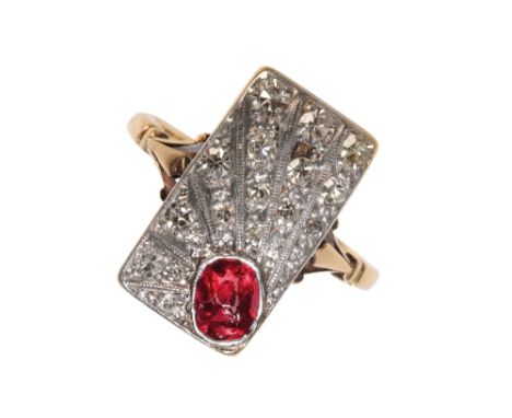 AN ART DECO DIAMOND AND RUBY RING the oval-cut ruby, collet-set to a plaque of diamond set rays,(one diamond missing) on an u