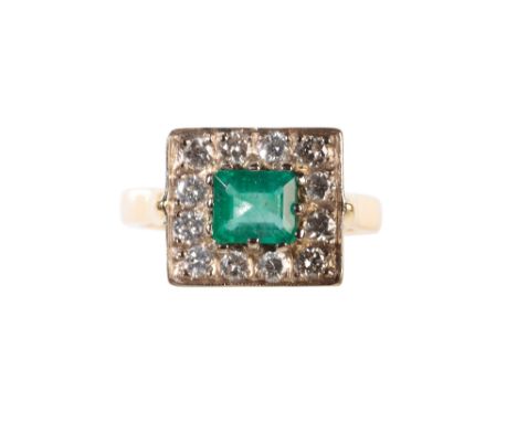 AN EMERALD AND DIAMOND CLUSTER RING the claw-set emerald surrounded by a border of twelve round-cut diamonds, on a yellow gol