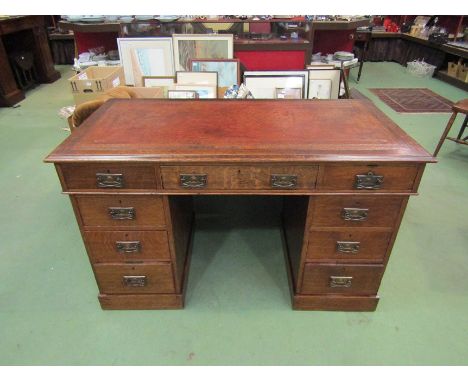 A late Victorian oak twin pedestal desk the tooled leather inset over nine drawers on ceramic castors, 78.5cm x 129.5cm x 63c