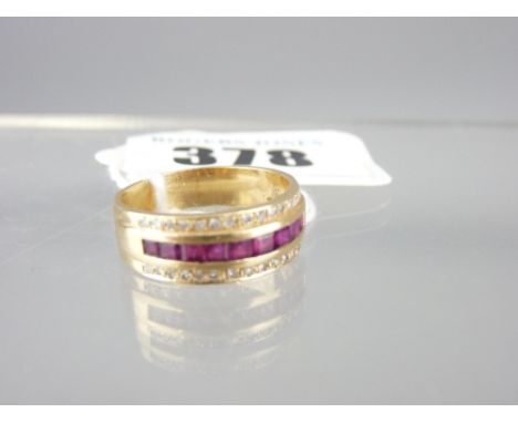 14CT GOLD RUBY &amp; DIAMOND HALF HOOP DRESS RING having nine square faceted rubies with a band of fourteen small round cut d