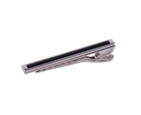 
	
		An onyx tie clip by William &amp; Son, the white gold bar set with a rectangular onyx panel, 5.5cm long, 18 carat gold L