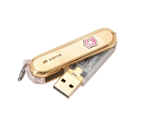 
	
		An 18 carat gold mounted Victorinox 'Swiss Army knife' USB memory stick, maker's mark CJR (not traced), London 2004, wit