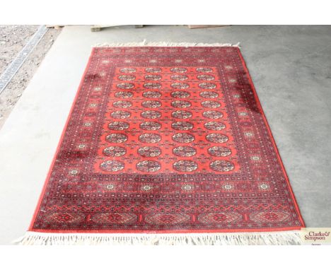 An approx 6'5" x 4'8" red patterned carpet