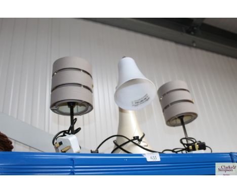 A pair of table lamps and a single table lamp