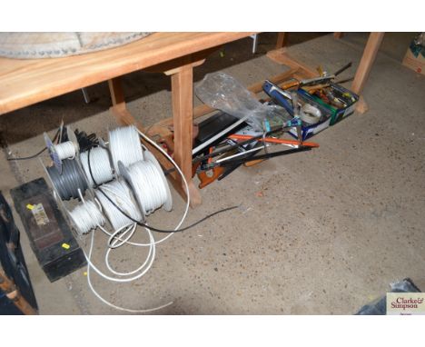 A collection of various tools to include a Dunlop junior foot pump, a tap re-seater, various reels of cable, hand saws, wrenc