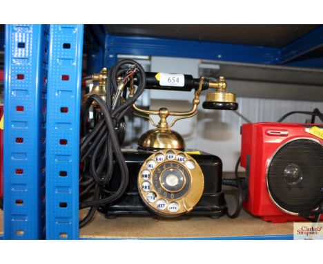 A vintage Bakelite and brass dial up telephone