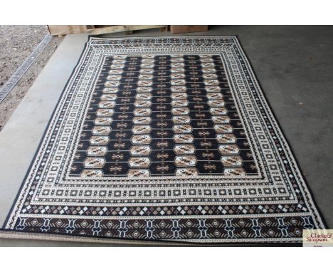 An approx 8'8" x 6' black patterned carpet