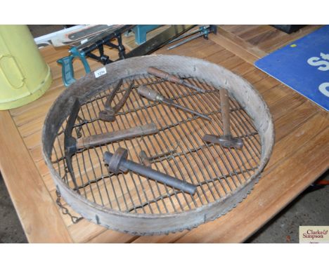 A garden sieve with attached tools