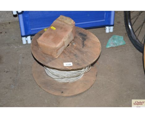 A galvanised iron jack chain and a reel of cloth woven cable
