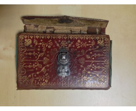A red morocco notebook formally Rider's Almanack for 1735, with most text leaves now removed and manuscript notes, 12mo; with