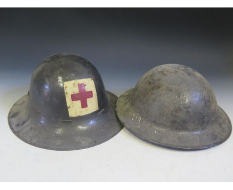 Two British Army Tin Helmets.  One painted with Red Cross and dated 1941.  Also two Vent Grills? 