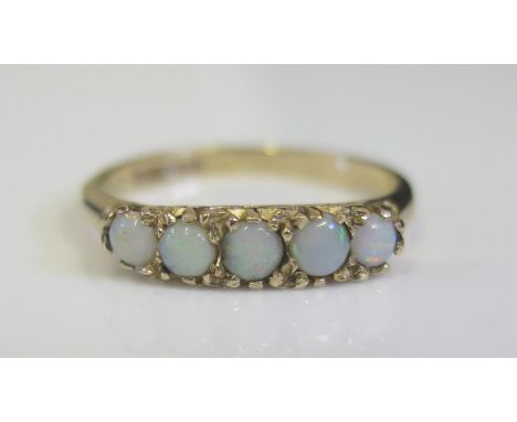 A 9ct Yellow Gold and White Opal Five Stone Ring, size M, 2.1g 