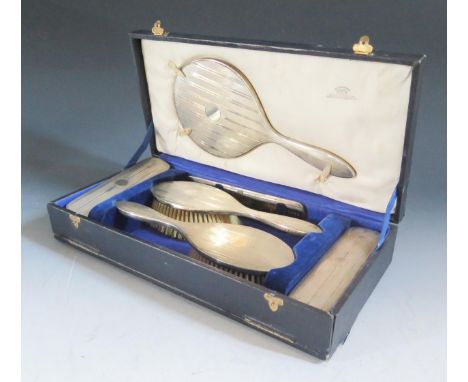 A Cased George V Silver Backed Six Part Hand Mirror, Brush and Comb Set, Birmingham 1928, Mappin &amp; Webb 