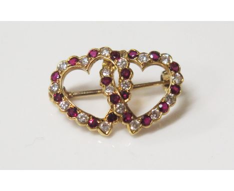 An 18ct Yellow Gold Entwined Hearts Ruby and Diamond Mounted Brooch by E. Wolfe &amp; Co. EDW. 58ct, 22mm diam., 2.8g 