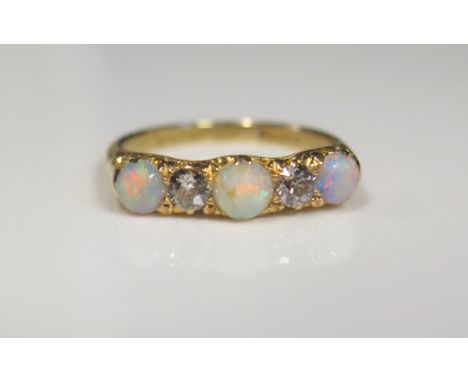 An 18ct Yellow Gold, Opal and Diamond Five Stone Ring, c. 3.2mm diamonds, size M.5, 3.4g 