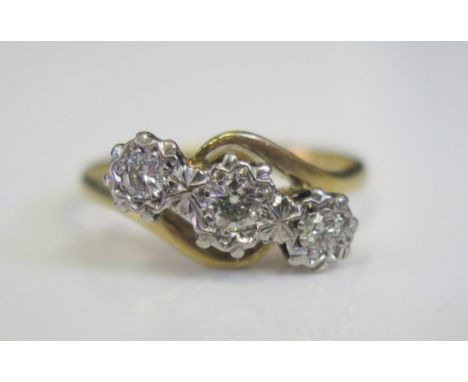 An 18ct Yellow Gold and Three Diamond Twist Ring in an illusion setting, size K.5, 3.3g 