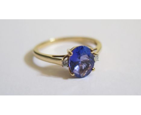 An 18ct Yellow Gold, Tanzanite and Diamond Three Stone Ring, tanzanite 9x7mm, size R.5, 3.4g 