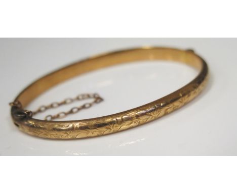 A Victorian 15ct Yellow Gold Hinged Bangle with chased foliate decoration, 60x47mm inside dimensions, Birmingham 1896, 7.2g. 