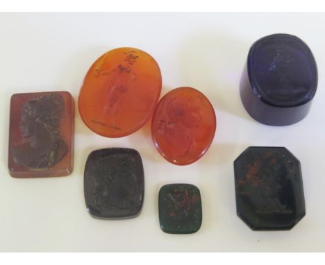 Various Antique Intaglios and seals including agate, bloodstone and amethyst glass: one decorated with a stag's head and the 