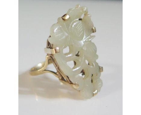 A Chinese 9ct Gold and Carved Jade Floral Decorated Ring, 33mm long, size N.5, N.5
