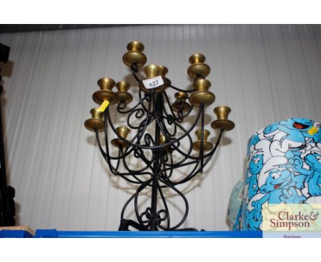A wrought metal and brass candelabra