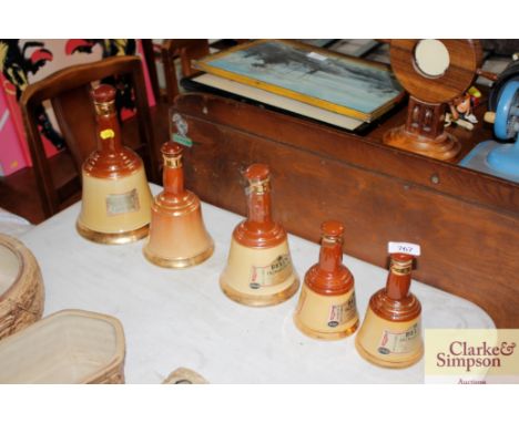 A graduated set of weighed Bells Scotch Whiskey decanters