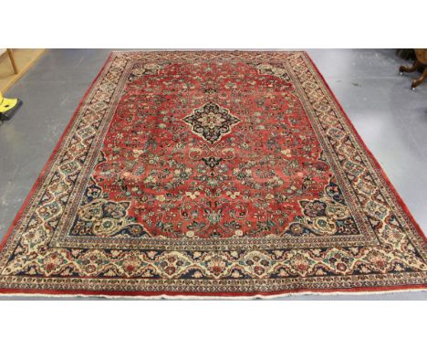 A Mahal carpet, North-west Persia, mid-20th century, the pink field with a small shaped medallion, supported by scrolling fol