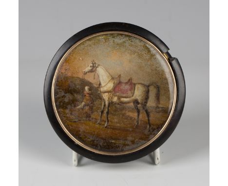An early/mid-19th century tortoiseshell and gold mounted circular snuff box, the glazed lid inset with a painted panel of a h