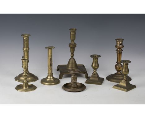A group of eight 18th century and later brass candlesticks, including two ejector candlesticks, one with petal base, height 2