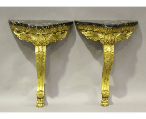 A pair of early 20th century French giltwood console tables, the grey marble tops raised on carved scroll supports, height 72
