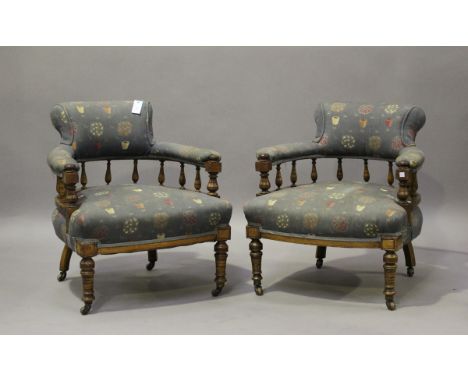 A pair of late Victorian walnut framed tub back chairs, on ring turned legs and castors, height 74cm, width 70cm, depth 73cm.